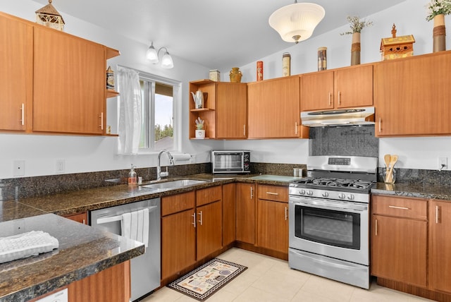 kitchen with sink, light tile patterned flooring, vaulted ceiling, and appliances with stainless steel finishes