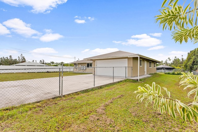 view of side of property with a lawn and a garage