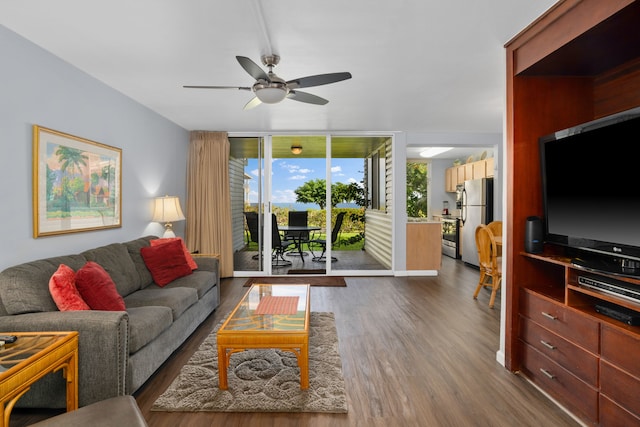 living room with floor to ceiling windows, ceiling fan, and dark wood-type flooring