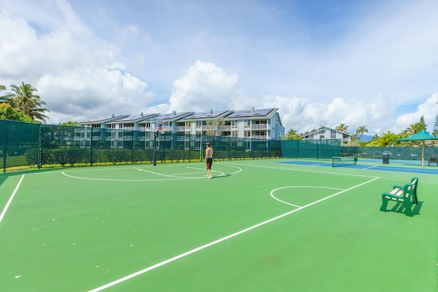 view of property's community with basketball hoop and tennis court