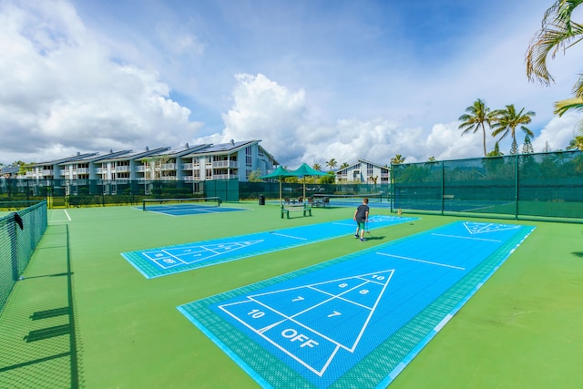 view of home's community with tennis court