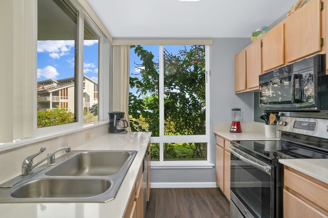 kitchen featuring dark hardwood / wood-style flooring, sink, stainless steel range with electric cooktop, and light brown cabinets