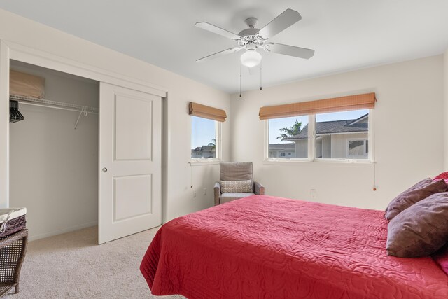 carpeted bedroom featuring ceiling fan and a closet