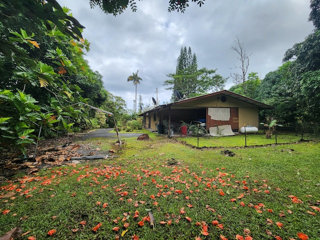 view of yard featuring an outbuilding, an outdoor structure, and fence