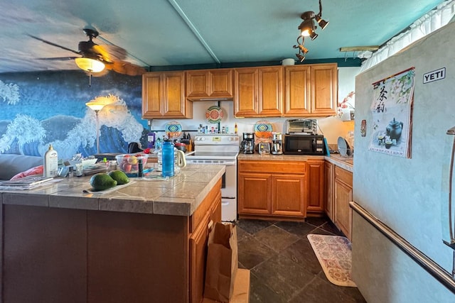 kitchen featuring ceiling fan, a kitchen island, and white appliances