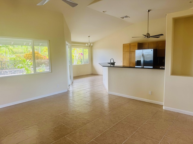 interior space with ceiling fan with notable chandelier, lofted ceiling, sink, and light tile patterned floors