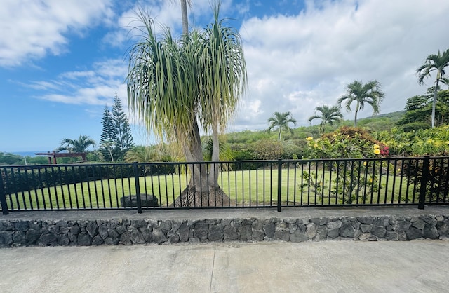 view of gate with a lawn