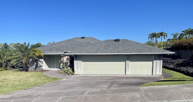 ranch-style home with a garage and a front lawn