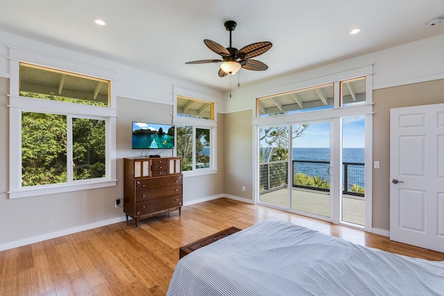 unfurnished bedroom featuring access to outside, ceiling fan, and light hardwood / wood-style flooring