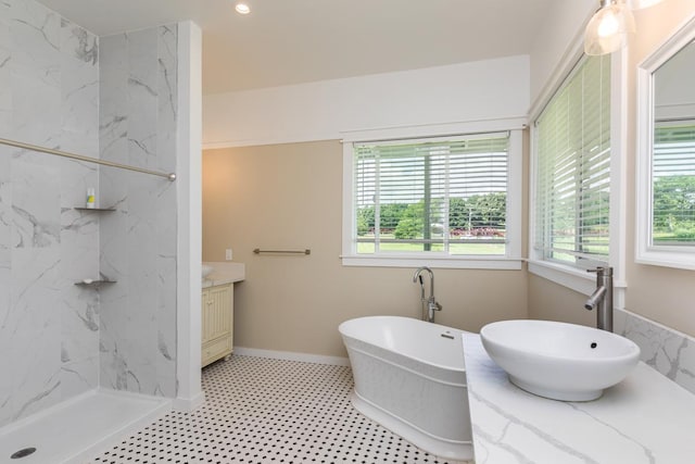 bathroom featuring plus walk in shower and vanity