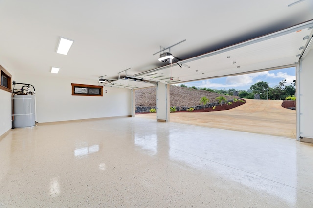 garage with gas water heater and a garage door opener