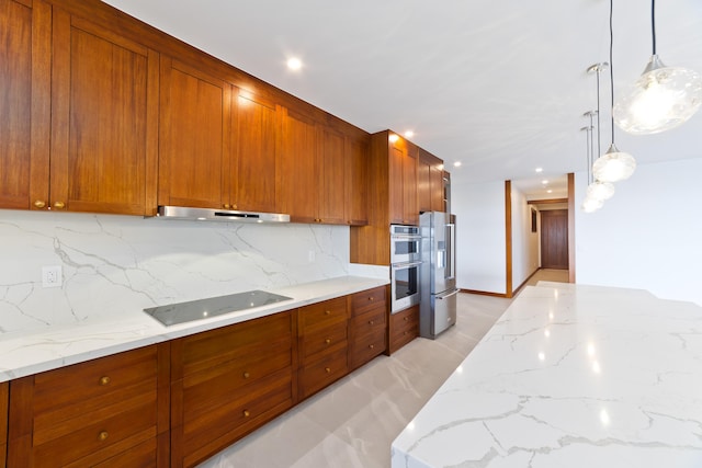 kitchen featuring hanging light fixtures, backsplash, light stone counters, and stainless steel appliances