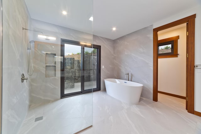 bathroom with separate shower and tub and tile walls