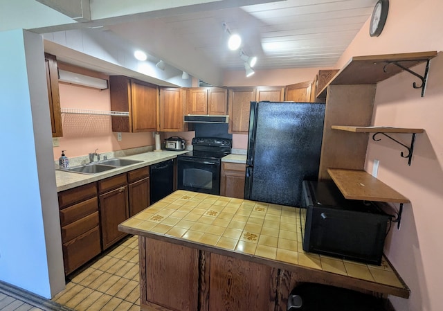 kitchen featuring exhaust hood, tile countertops, track lighting, black appliances, and sink