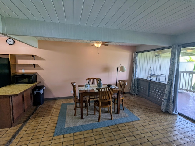 tiled dining area featuring wooden ceiling and ceiling fan