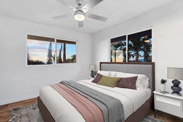 bedroom with dark hardwood / wood-style floors and ceiling fan