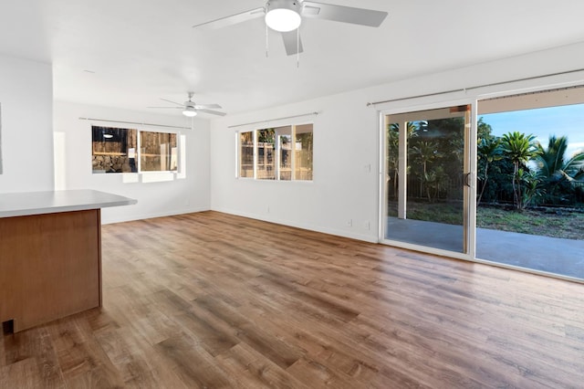 unfurnished living room featuring hardwood / wood-style flooring and ceiling fan