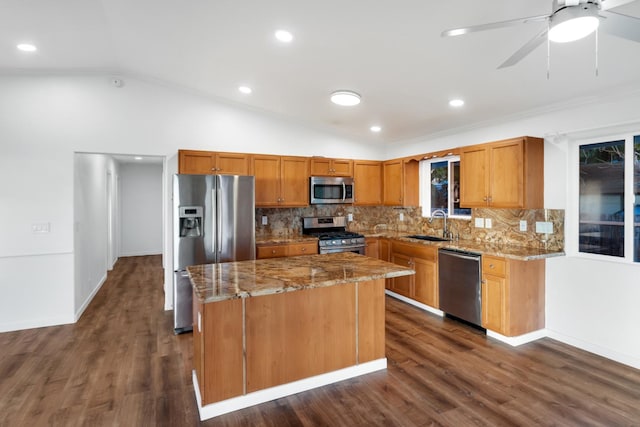 kitchen with appliances with stainless steel finishes, a center island, dark hardwood / wood-style flooring, and lofted ceiling