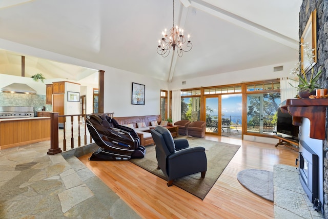 living room featuring beamed ceiling and high vaulted ceiling