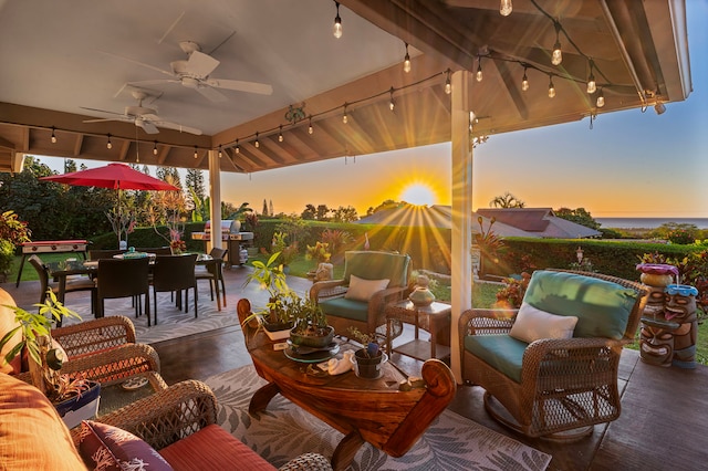 patio terrace at dusk featuring an outdoor hangout area and ceiling fan