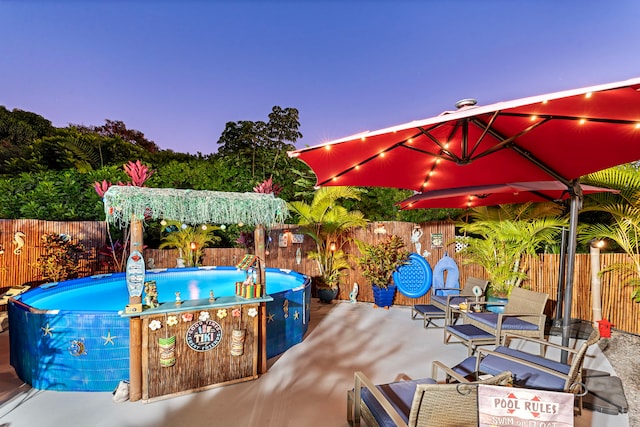 view of pool at dusk