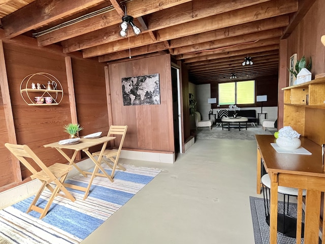 interior space featuring concrete floors and wood walls