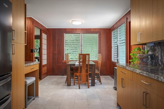 dining area with wooden walls