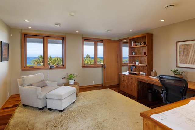 office featuring baseboards, wood finished floors, and recessed lighting