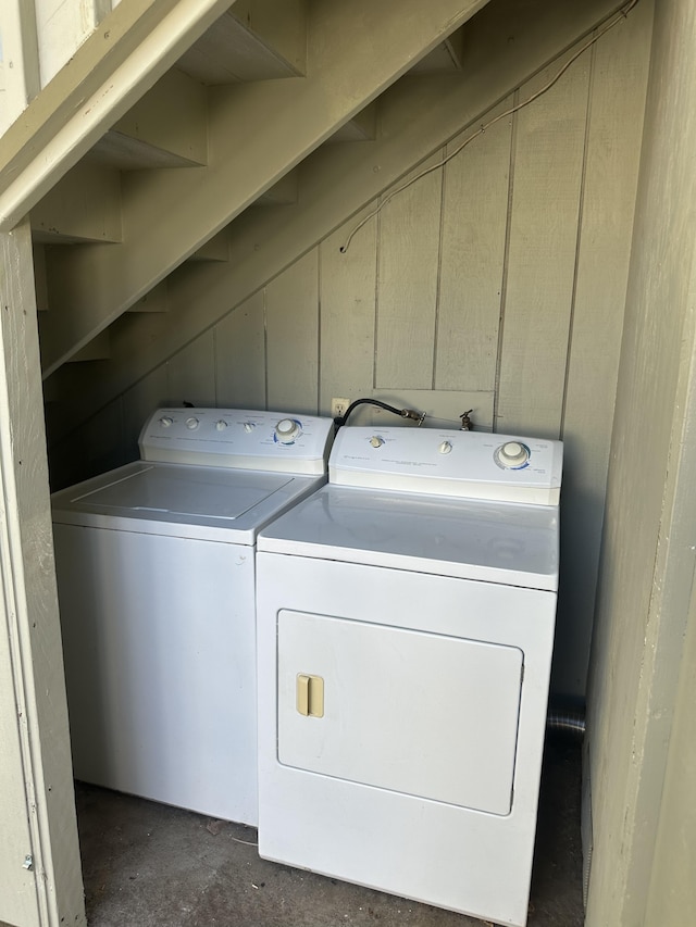 clothes washing area with separate washer and dryer