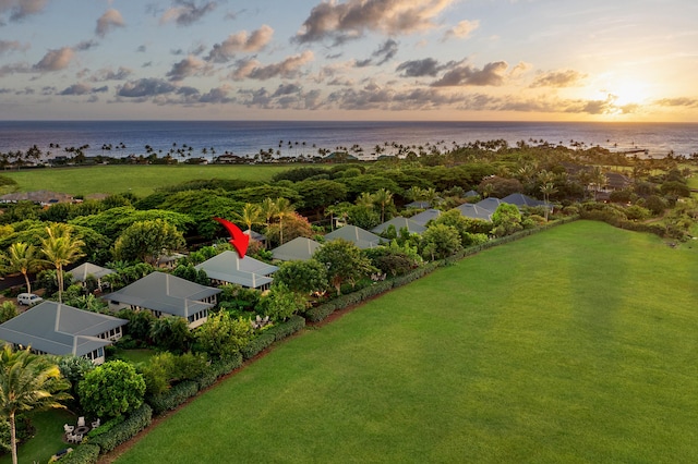 aerial view at dusk featuring a water view