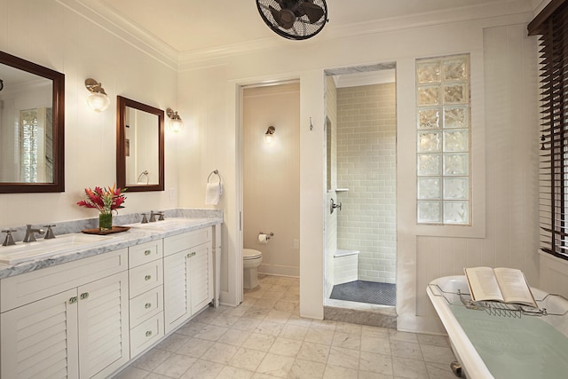 bathroom with crown molding, toilet, a tile shower, and vanity