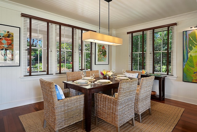 dining area featuring crown molding, a healthy amount of sunlight, and dark hardwood / wood-style flooring