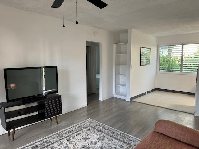 unfurnished living room with hardwood / wood-style floors, a textured ceiling, and ceiling fan