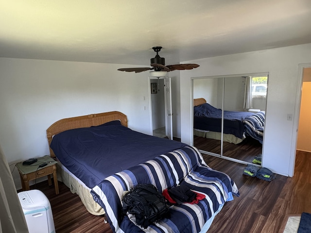 bedroom with vaulted ceiling, ceiling fan, a closet, and dark hardwood / wood-style floors