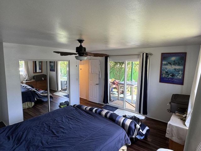 bedroom featuring access to exterior, dark hardwood / wood-style flooring, a textured ceiling, ceiling fan, and a closet