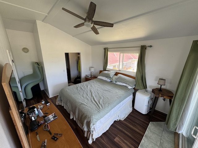 bedroom featuring ceiling fan, dark hardwood / wood-style floors, and lofted ceiling