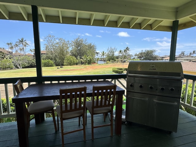 deck featuring grilling area and a lawn