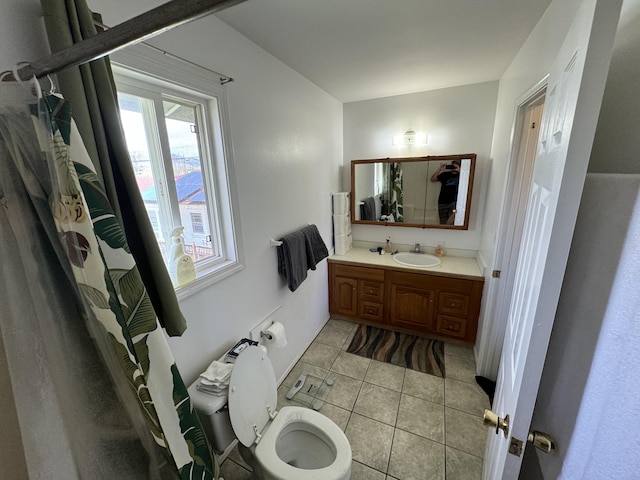 bathroom featuring tile patterned flooring, vanity, and toilet