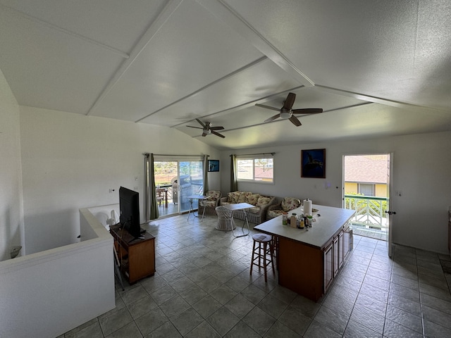 kitchen featuring a center island, plenty of natural light, and lofted ceiling