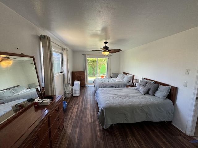 bedroom featuring a textured ceiling, ceiling fan, and dark wood-type flooring