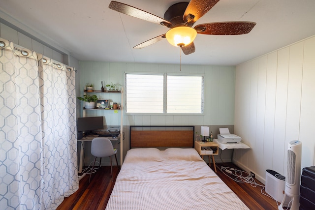 bedroom with dark hardwood / wood-style flooring and ceiling fan