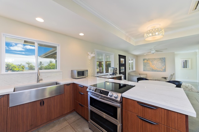 kitchen with kitchen peninsula, ceiling fan, sink, light tile patterned floors, and stainless steel electric range