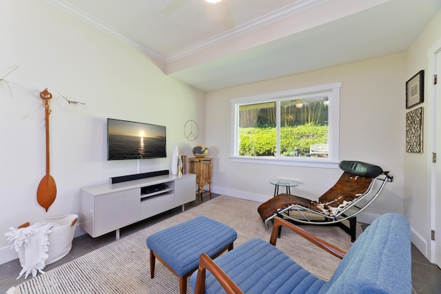 sitting room featuring dark tile patterned floors, ceiling fan, and ornamental molding