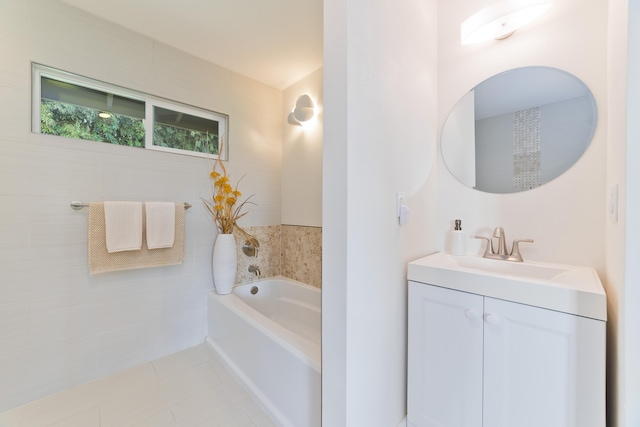 bathroom with tile patterned flooring, vanity, and a bath