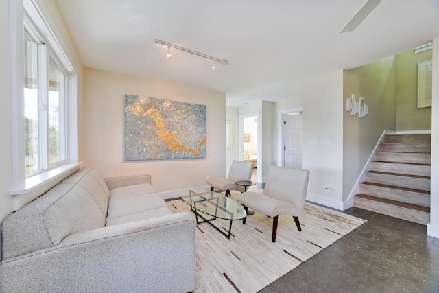 living room with concrete flooring and track lighting