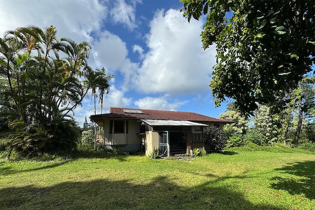 back of property featuring a lawn