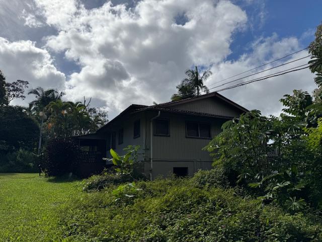 view of side of home with a lawn