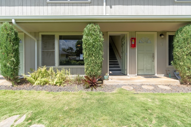 view of exterior entry with a lawn