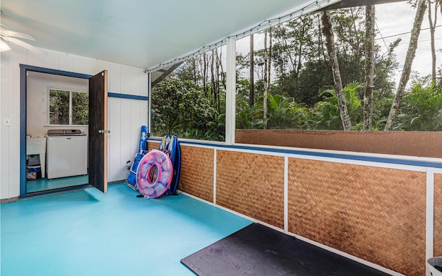 unfurnished sunroom with washer / clothes dryer and ceiling fan