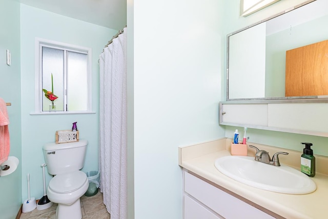 bathroom with tile patterned flooring, vanity, and toilet